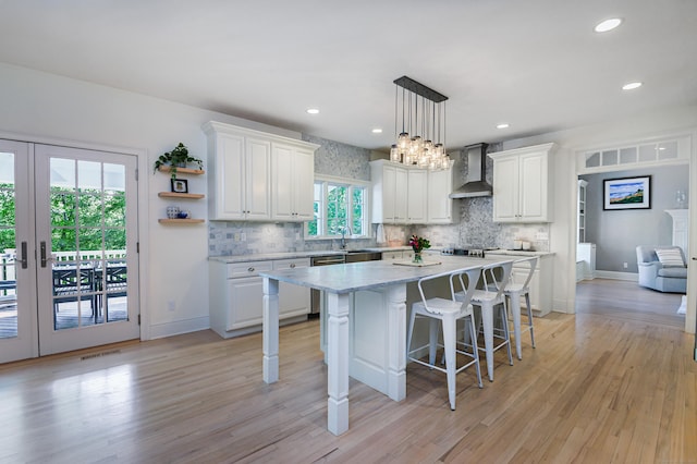 68 Topstone Rd, Ridgefield, CT 06877 - kitchen featuring wall chimney range hood, white cabinets, tasteful backsplash, and recessed lighting