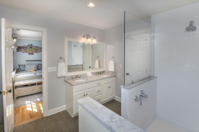 68 Topstone Rd, Ridgefield, CT 06877 - full bath with double vanity, walk in shower, wood finish floors, baseboards, and recessed lighting
