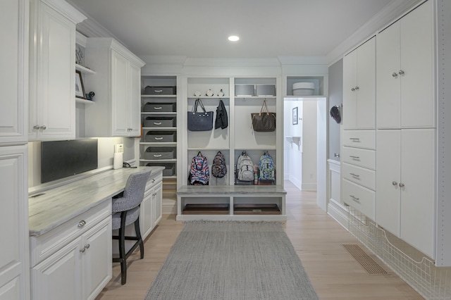 68 Topstone Rd, Ridgefield, CT 06877 - mudroom with light wood finished floors, built in desk, and recessed lighting