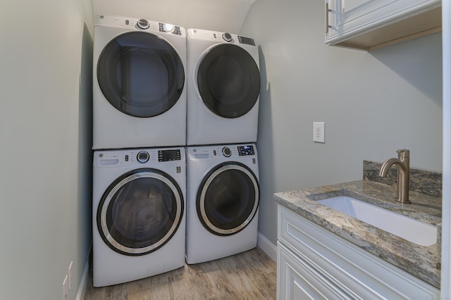 68 Topstone Rd, Ridgefield, CT 06877 - washroom with stacked washer and clothes dryer, cabinet space, light wood-style floors, and independent washer and dryer