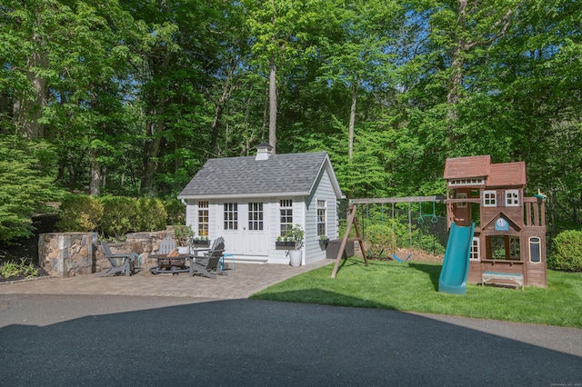68 Topstone Rd, Ridgefield, CT 06877 - view of patio featuring a fire pit, a playground, and an outbuilding