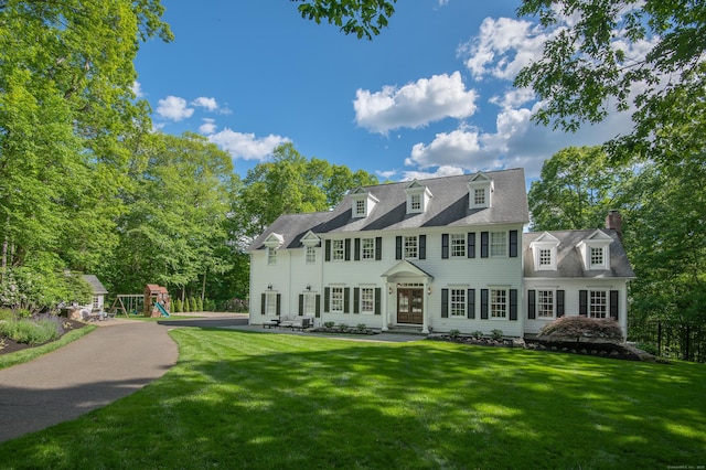 68 Topstone Rd, Ridgefield, CT 06877 - view of front facade with a front lawn, a playground, a chimney, and french doors
