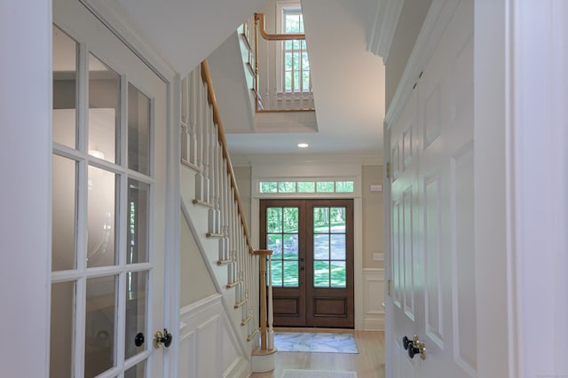 68 Topstone Rd, Ridgefield, CT 06877 - entrance foyer featuring french doors, a decorative wall, stairs, healthy amount of natural light, and wainscoting
