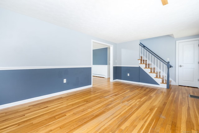 10 Cartier Rd, Enfield, CT 06082 - unfurnished room featuring a baseboard heating unit, wood finished floors, stairway, and baseboards