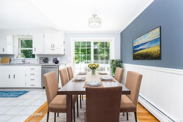 10 Cartier Rd, Enfield, CT 06082 - dining area featuring baseboard heating, ornamental molding, wainscoting, and light wood-type flooring