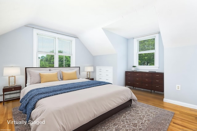 10 Cartier Rd, Enfield, CT 06082 - bedroom featuring multiple windows, light wood-style flooring, vaulted ceiling, baseboards, and a baseboard radiator