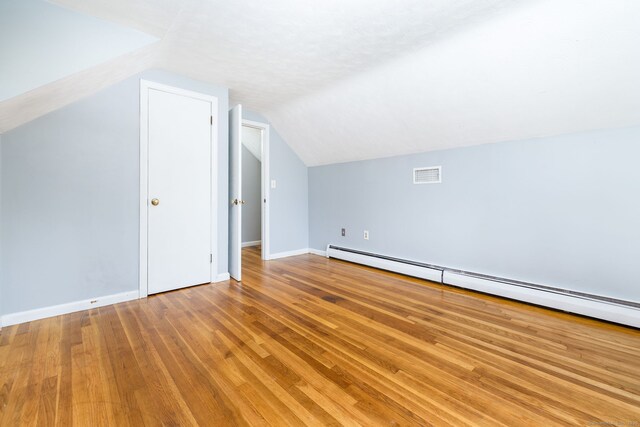 10 Cartier Rd, Enfield, CT 06082 - bonus room with a baseboard radiator, vaulted ceiling, wood finished floors, and baseboards