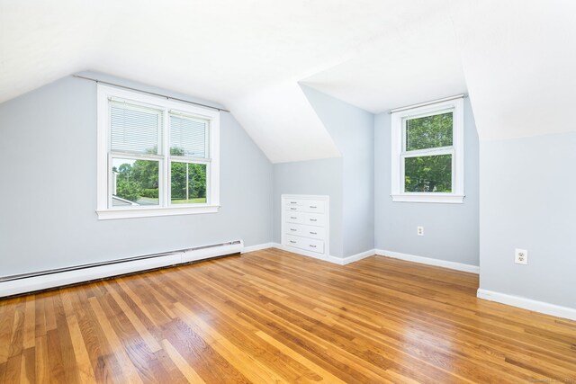 10 Cartier Rd, Enfield, CT 06082 - bonus room featuring plenty of natural light, light wood finished floors, vaulted ceiling, a baseboard heating unit, and baseboards