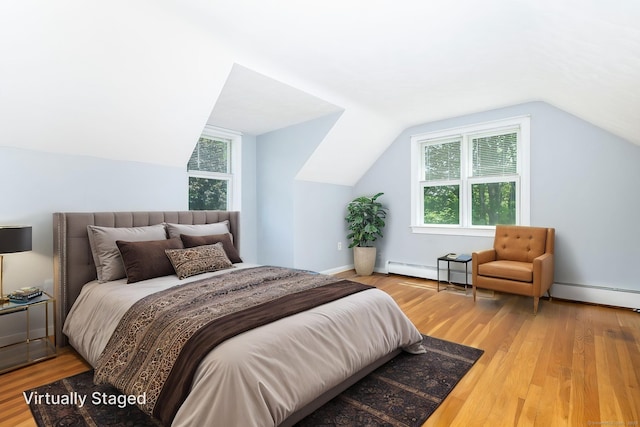 10 Cartier Rd, Enfield, CT 06082 - bedroom with baseboard heating, wood finished floors, multiple windows, and vaulted ceiling