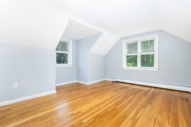 10 Cartier Rd, Enfield, CT 06082 - additional living space featuring light wood-style flooring, healthy amount of natural light, a baseboard radiator, and lofted ceiling