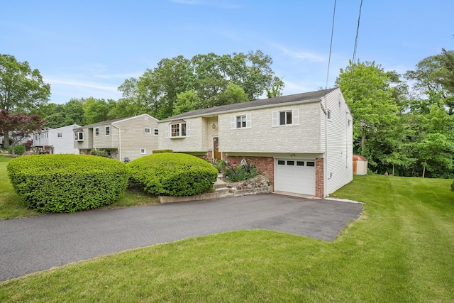 15 Amherst Pl, Stamford, CT 06902 - split foyer home with brick siding, an attached garage, driveway, and a front yard