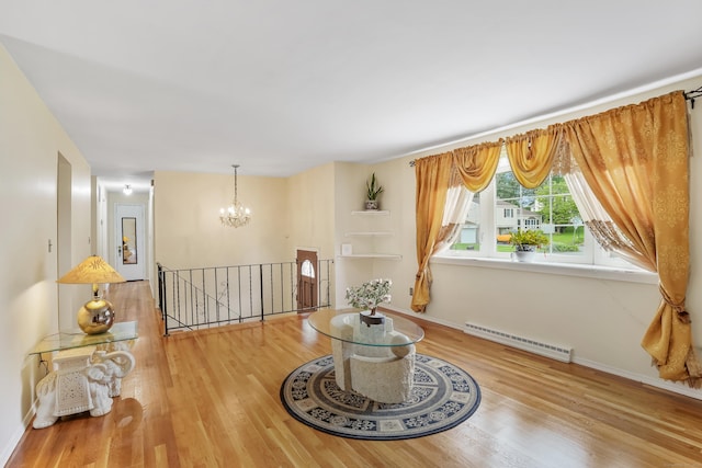 15 Amherst Pl, Stamford, CT 06902 - sitting room featuring an upstairs landing, baseboard heating, a chandelier, wood finished floors, and baseboards
