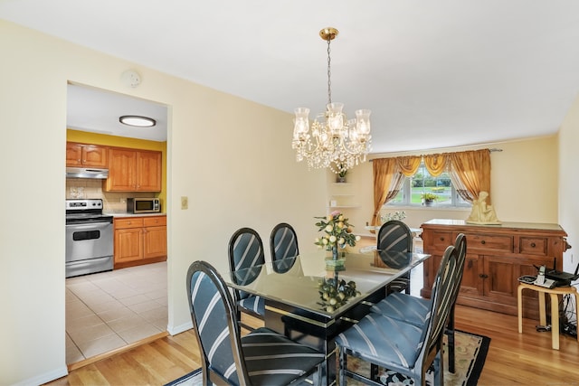 15 Amherst Pl, Stamford, CT 06902 - dining area with a chandelier, light wood-type flooring, and baseboards