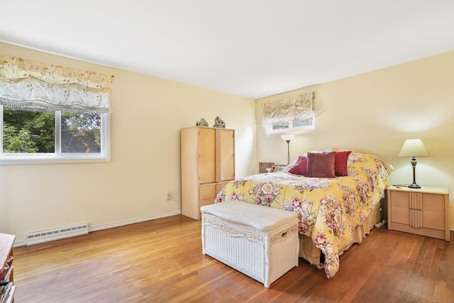 15 Amherst Pl, Stamford, CT 06902 - bedroom featuring a baseboard heating unit, wood finished floors, and baseboards