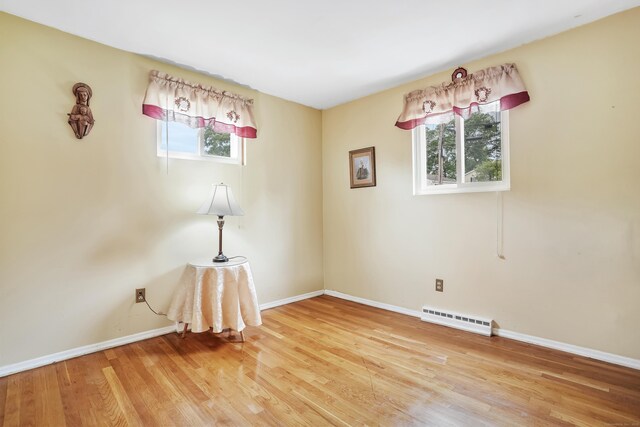 15 Amherst Pl, Stamford, CT 06902 - unfurnished room featuring healthy amount of natural light, a baseboard radiator, and light wood-style flooring