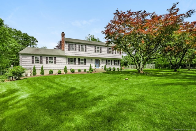 290 Fillow St, Norwalk, CT 06850 - colonial house featuring a chimney and a front lawn