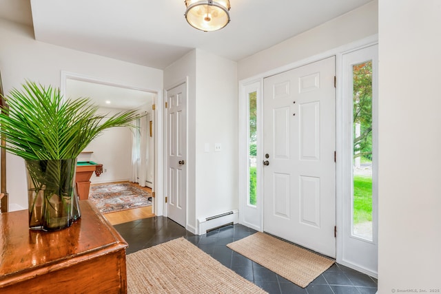 290 Fillow St, Norwalk, CT 06850 - entrance foyer with a baseboard radiator, dark tile patterned floors, and healthy amount of natural light