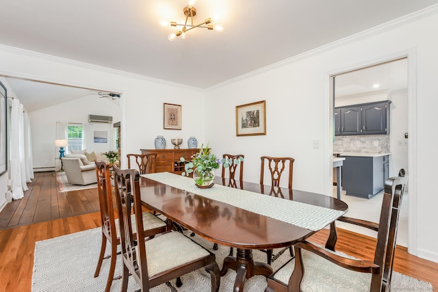 290 Fillow St, Norwalk, CT 06850 - dining area featuring a wall mounted AC, light wood-type flooring, a chandelier, and crown molding
