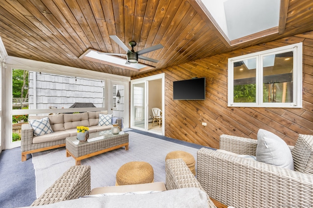 290 Fillow St, Norwalk, CT 06850 - carpeted living area featuring a skylight, wood walls, ceiling fan, wood ceiling, and vaulted ceiling