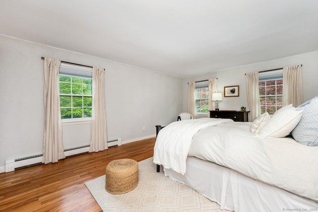 290 Fillow St, Norwalk, CT 06850 - bedroom featuring wood finished floors, baseboard heating, and baseboards