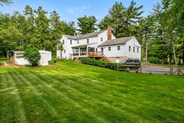 290 Fillow St, Norwalk, CT 06850 - back of house featuring a sunroom, a lawn, and a wooden deck