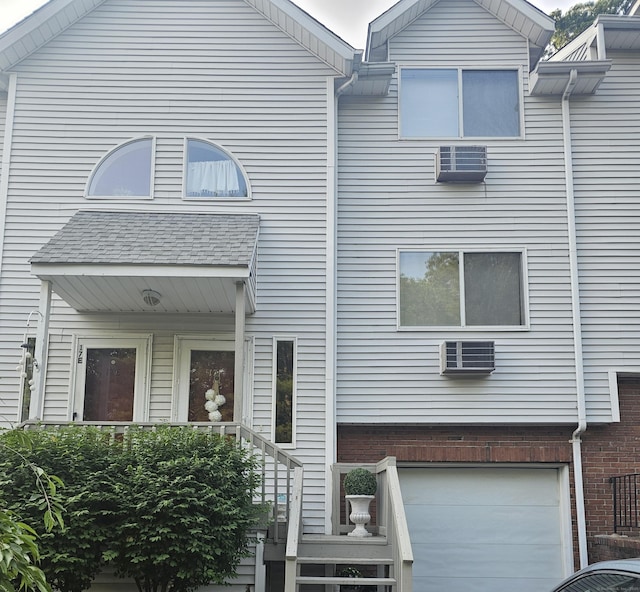 925 Oronoke Rd Unit 17F, Waterbury, CT 06708 - multi unit property with a garage, a wall unit AC, and brick siding