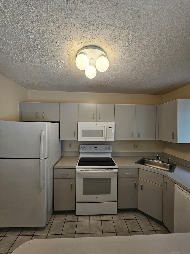 925 Oronoke Rd Unit 17F, Waterbury, CT 06708 - kitchen featuring white appliances, a textured ceiling, light tile patterned floors, and light countertops