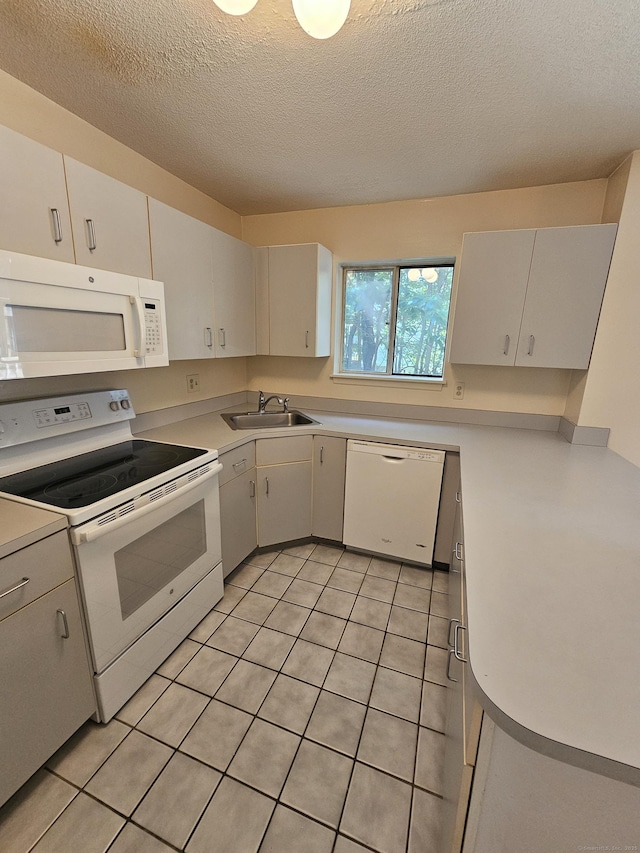 925 Oronoke Rd Unit 17F, Waterbury, CT 06708 - kitchen with white appliances, light countertops, a textured ceiling, and white cabinetry