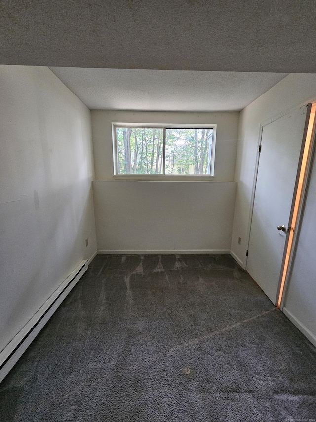 925 Oronoke Rd Unit 17F, Waterbury, CT 06708 - empty room featuring a baseboard radiator, dark carpet, plenty of natural light, and a textured ceiling