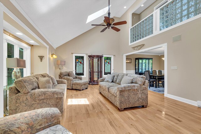 48 Shepherds Trl, Madison, CT 06443 - living area featuring high vaulted ceiling, a ceiling fan, light wood-type flooring, baseboards, and a skylight