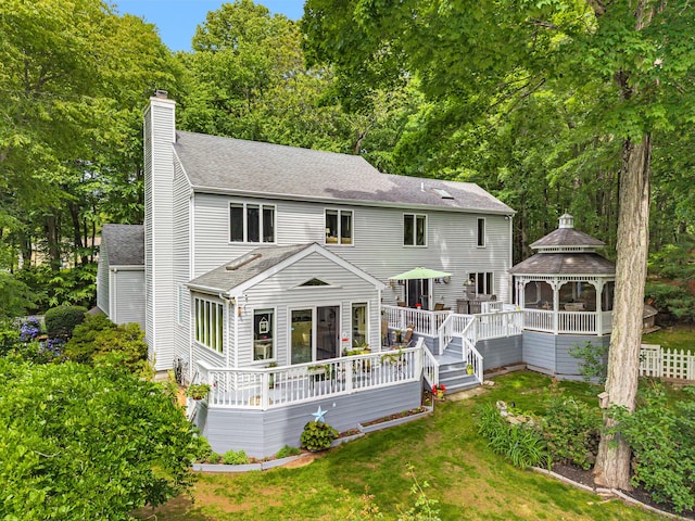 48 Shepherds Trl, Madison, CT 06443 - back of house with a gazebo, a shingled roof, a chimney, a deck, and a lawn