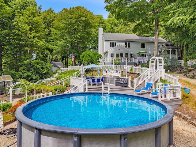 48 Shepherds Trl, Madison, CT 06443 - view of swimming pool with a wooden deck, stairs, and view of scattered trees