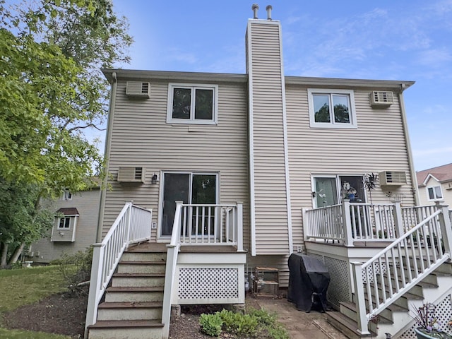 245 E Woodland St Apt 14, Meriden, CT 06451 - rear view of house with stairway, a wooden deck, a chimney, and a wall mounted air conditioner