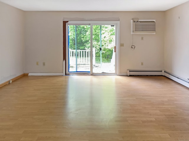 245 E Woodland St Apt 14, Meriden, CT 06451 - unfurnished room with a wall mounted AC, light wood-type flooring, and baseboards