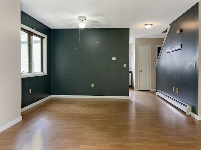 245 E Woodland St Apt 14, Meriden, CT 06451 - unfurnished room with a baseboard radiator, ceiling fan, baseboards, and light wood-style floors