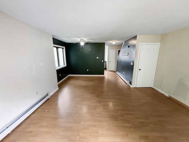 245 E Woodland St Apt 14, Meriden, CT 06451 - unfurnished room with baseboard heating, a ceiling fan, baseboards, and light wood-type flooring