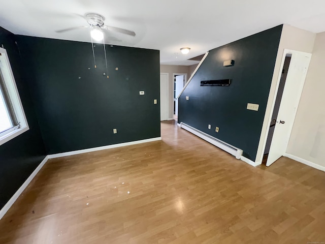 245 E Woodland St Apt 14, Meriden, CT 06451 - spare room with a baseboard radiator, a ceiling fan, light wood-style flooring, and baseboards