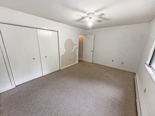 245 E Woodland St Apt 14, Meriden, CT 06451 - unfurnished bedroom featuring light carpet, a closet, baseboard heating, ceiling fan, and baseboards
