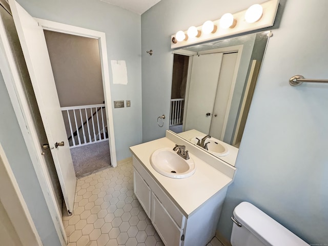 245 E Woodland St Apt 14, Meriden, CT 06451 - bathroom with vanity, toilet, and tile patterned floors