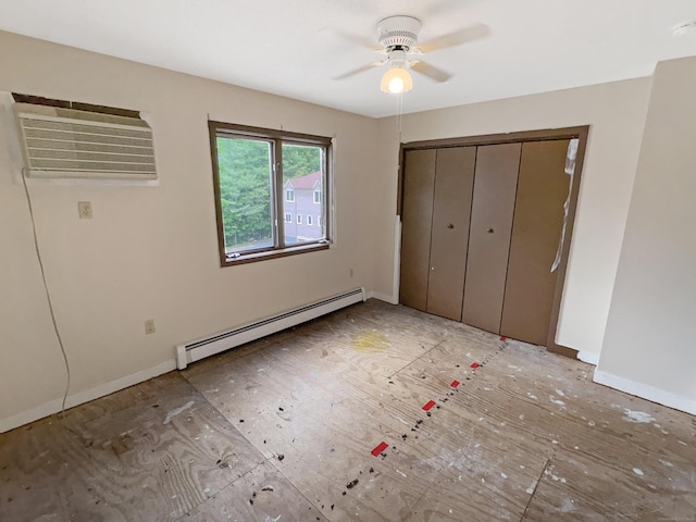245 E Woodland St Apt 14, Meriden, CT 06451 - unfurnished bedroom featuring baseboard heating, a wall mounted air conditioner, baseboards, and a closet