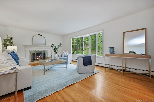 32 Jeffrey Rd, Greenwich, CT 06830 - living area with baseboard heating, wood finished floors, and a fireplace with flush hearth