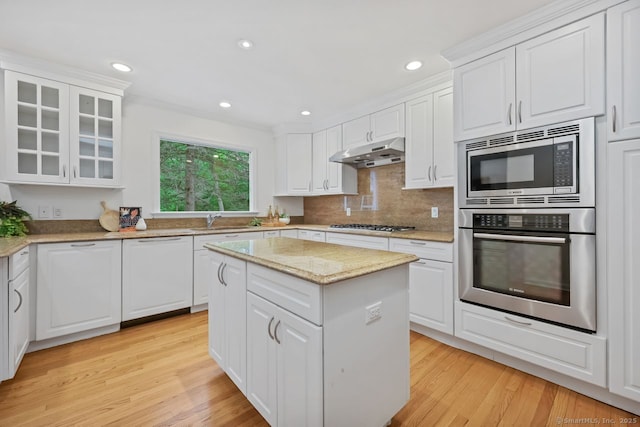 32 Jeffrey Rd, Greenwich, CT 06830 - kitchen with stainless steel appliances, under cabinet range hood, white cabinetry, and recessed lighting