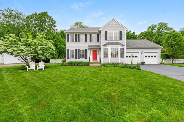 125 Longview Dr, Stratford, CT 06614 - view of front of house with a chimney, an attached garage, driveway, and a shingled roof
