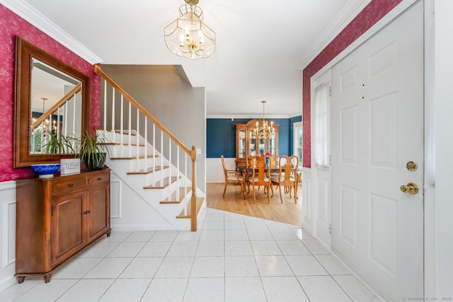 125 Longview Dr, Stratford, CT 06614 - entryway featuring a chandelier, ornamental molding, stairs, wainscoting, and light tile patterned floors