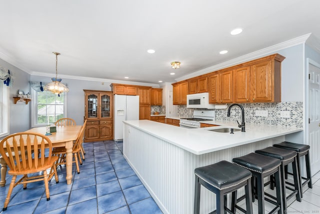 125 Longview Dr, Stratford, CT 06614 - kitchen with white appliances, a sink, light countertops, a peninsula, and tile patterned floors