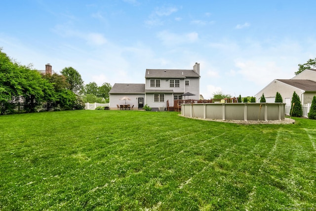 125 Longview Dr, Stratford, CT 06614 - back of house with an outdoor pool, a chimney, and a wooden deck