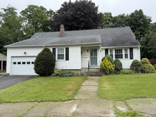 284 Gilbert Ave, Winchester, CT 06098 - view of front of home with a chimney, a front lawn, a garage, and driveway