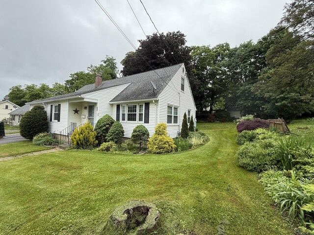 284 Gilbert Ave, Winchester, CT 06098 - view of front of home with a chimney, a front lawn, and roof with shingles