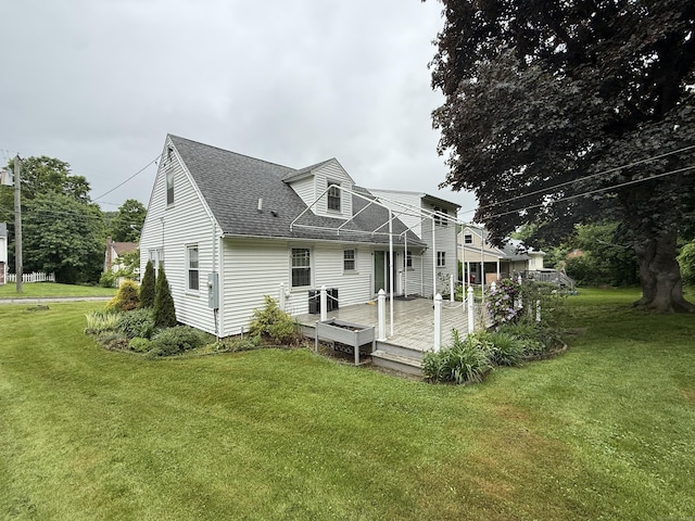 284 Gilbert Ave, Winchester, CT 06098 - rear view of property featuring roof with shingles, a wooden deck, and a yard