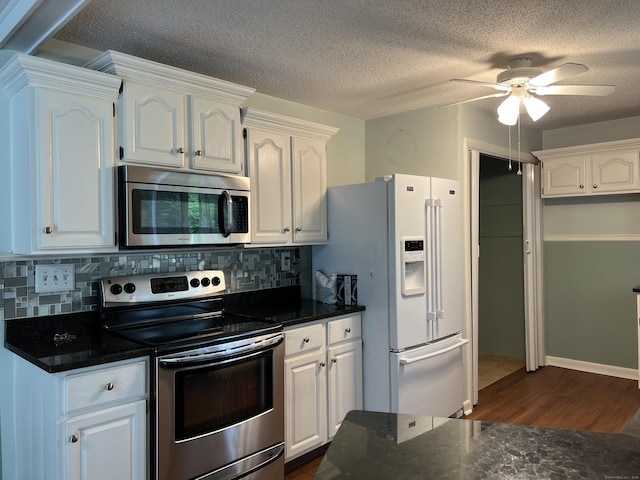 284 Gilbert Ave, Winchester, CT 06098 - kitchen with stainless steel appliances, dark wood-style floors, white cabinetry, decorative backsplash, and a textured ceiling